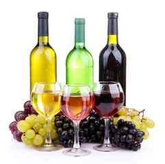 bottles and glasses of wine and assortment of grapes, isolated