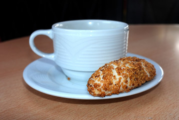 little bun on plate with cup close-up