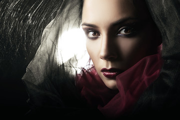 mysterious woman in black hood and web