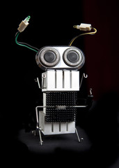 cute funny robot toy made of garbage. recycling waste