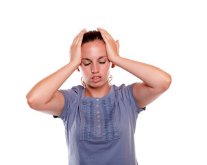 Young woman with headache holding her forehead