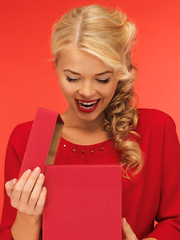 lovely woman in red dress with opened gift box