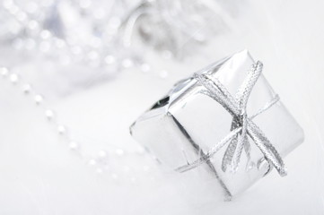 Silver gift box on gray brilliant background for merry christmas