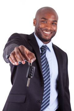 Young African American businessman holding a car key.
