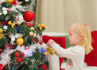 Baby decorating Christmas tree
