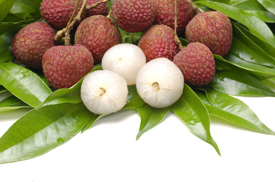 lychee and andpeeled lychee with leaf on white