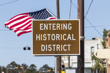 Fototapeta premium Entering Historical District Road Sign with American Flag