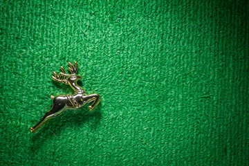 golden raindeer jumping on green carpet.