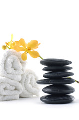 spa concept with orchid on towel and stones
