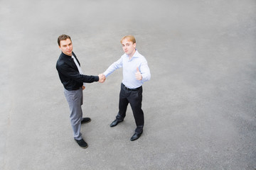 business partners concluded a bargain on the street