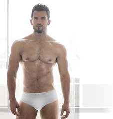 Sexy young male muscular model in white underwear
