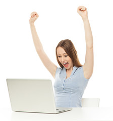 Woman raising her arms in front of laptop