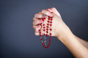 rosary with female hand - obrazy, fototapety, plakaty