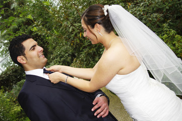 Bride is dressing up groom