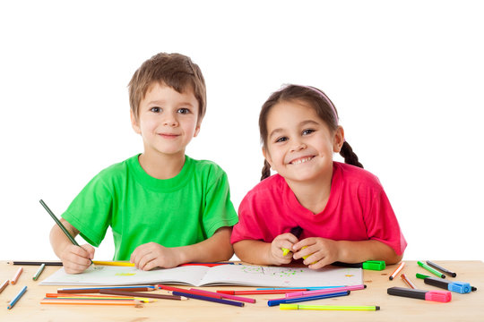 Two little kids draw with crayons