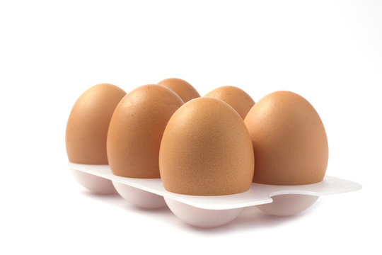 Eggs on a stand on white background