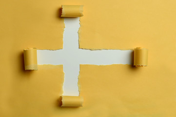 Rip paper in the shape of the cross