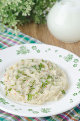 Cabbage and mashed potatoes on a plate on the table, closeup