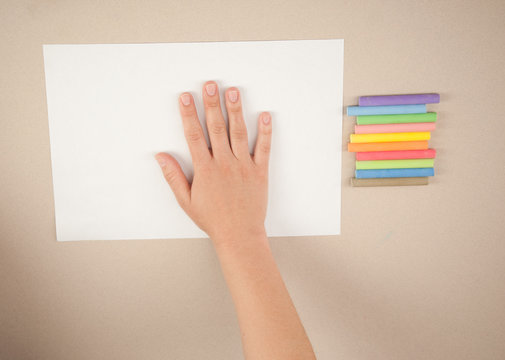 child draws a picture with chalks