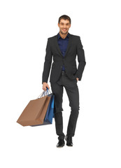 handsome man in suit with shopping bags