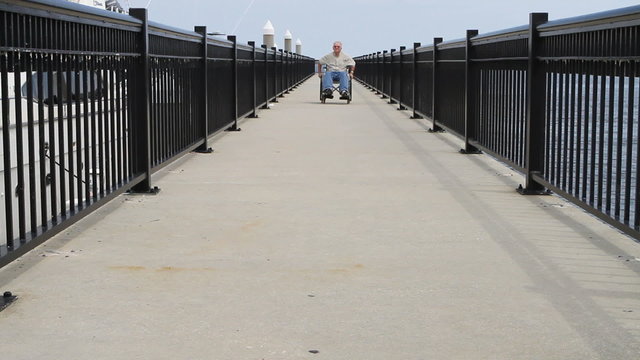 Man Rolling Forward Wheelchair