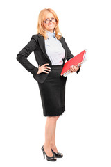 Smiling female teacher holding a notebook