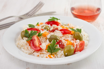 rice salad with tomato and olives on the plate