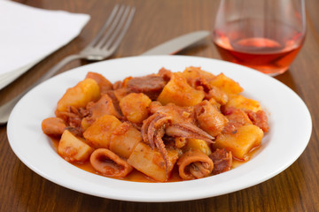 squid with potato and tomato sauce on the plate