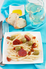 salad with chorizo on the plate and glass of wine