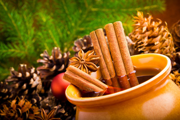 Mulled wine in brown jug with cinnamon and anise