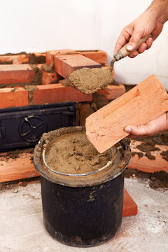 Masonry worker hands closeup