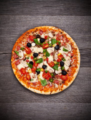 Delicious italian pizza served on wooden table