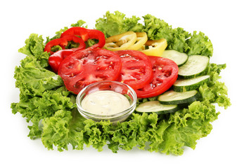 Chopped vegetables and sauce on plate isolated on white