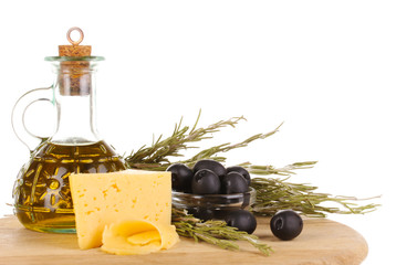 Black olives in white bowl with rosemary,olive oil and cheese