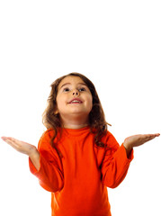 little curly brunette girl in orange sweater looks up and waits