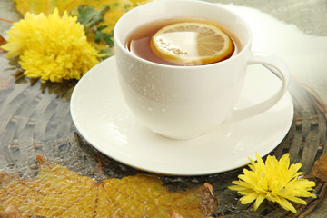 cup of hot drink and autumn leaves, close up