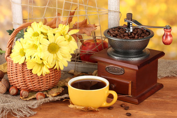 autumnal composition:coffee grinder, flowers  and leaves