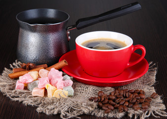 Red cup of coffee with rahat delight, milk and coffee pot