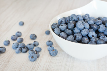 White bowl cup with fresh ripe blueberries