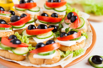 Canape with cheese feta and vegetables
