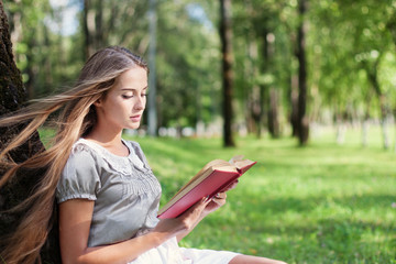 Fototapeta premium beautiful girl with book outdoor