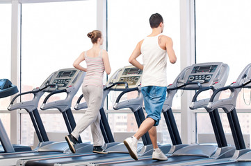 Fototapeta na wymiar Woman and man at the gym exercising.