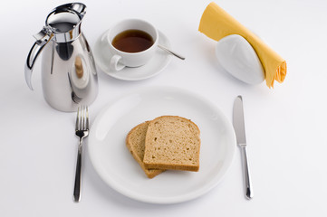 Breakfast table with thermos cup , olive, tomato and bread