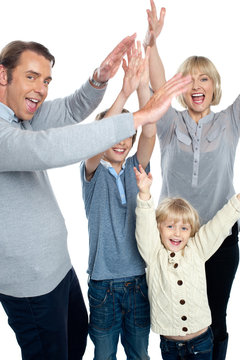 Jubilant family celebrating and partying indoors