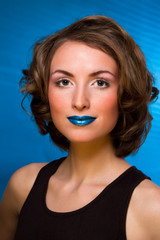 Fashion portrait of woman with fashion makeup - blue lips, blue