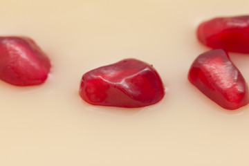 juicy ripe red pomegranate in milk