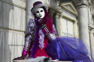 Person in Venetian costume attends the Carnival of Venice.
