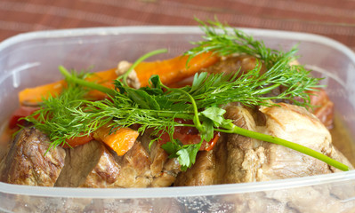 Roast beef cooked with vegetables and greens closeup