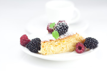 cup, cake, raspberry, blackberry,nuts and mint on a plate on a w