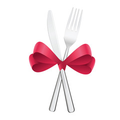 Festive flatware set, fork and knife tied with red satin ribbon